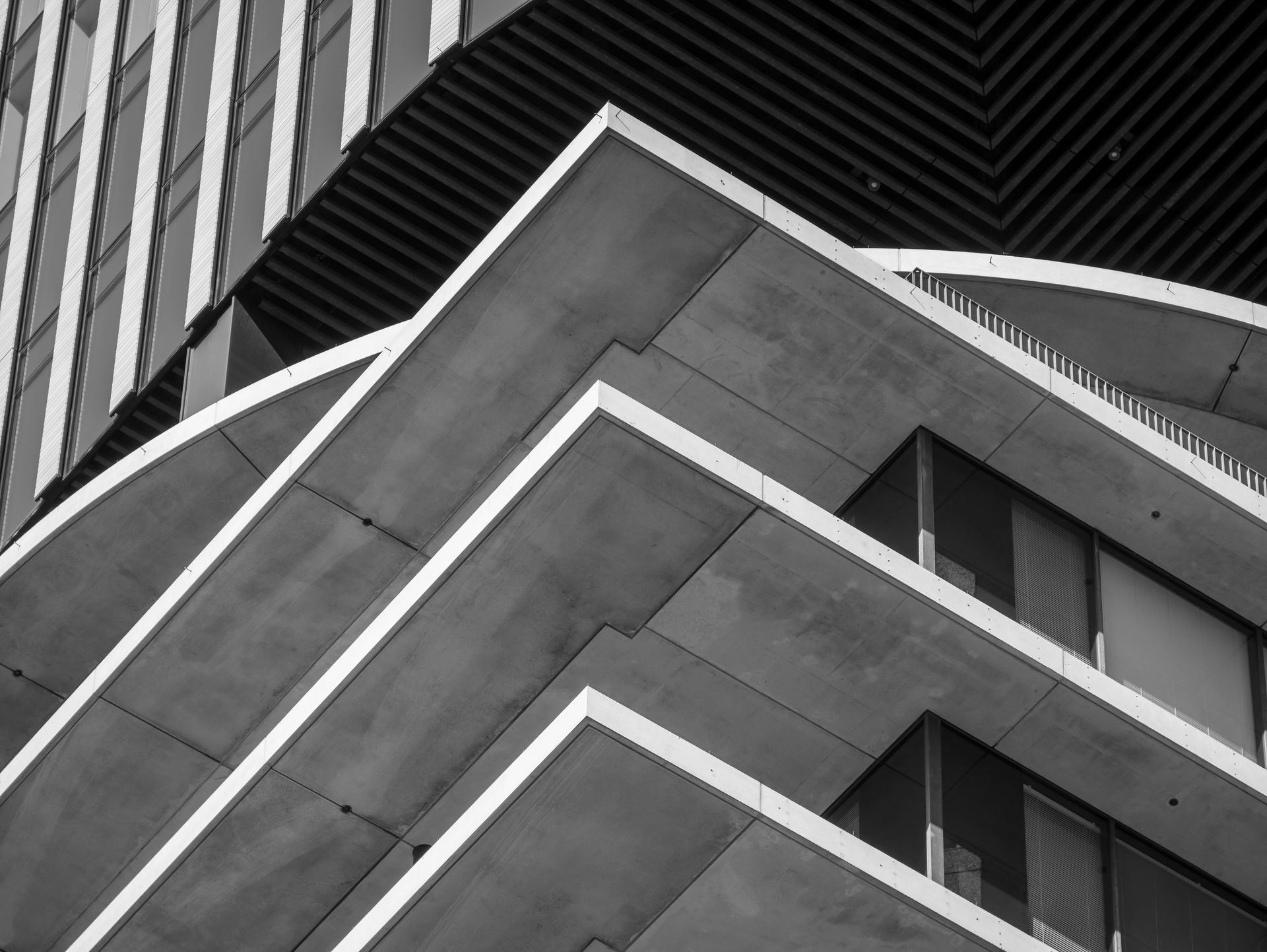 Black-and-white view of a modern geometric building facade with sharp angular lines Black-and-white view of a modern geometric building facade with sharp angular lines