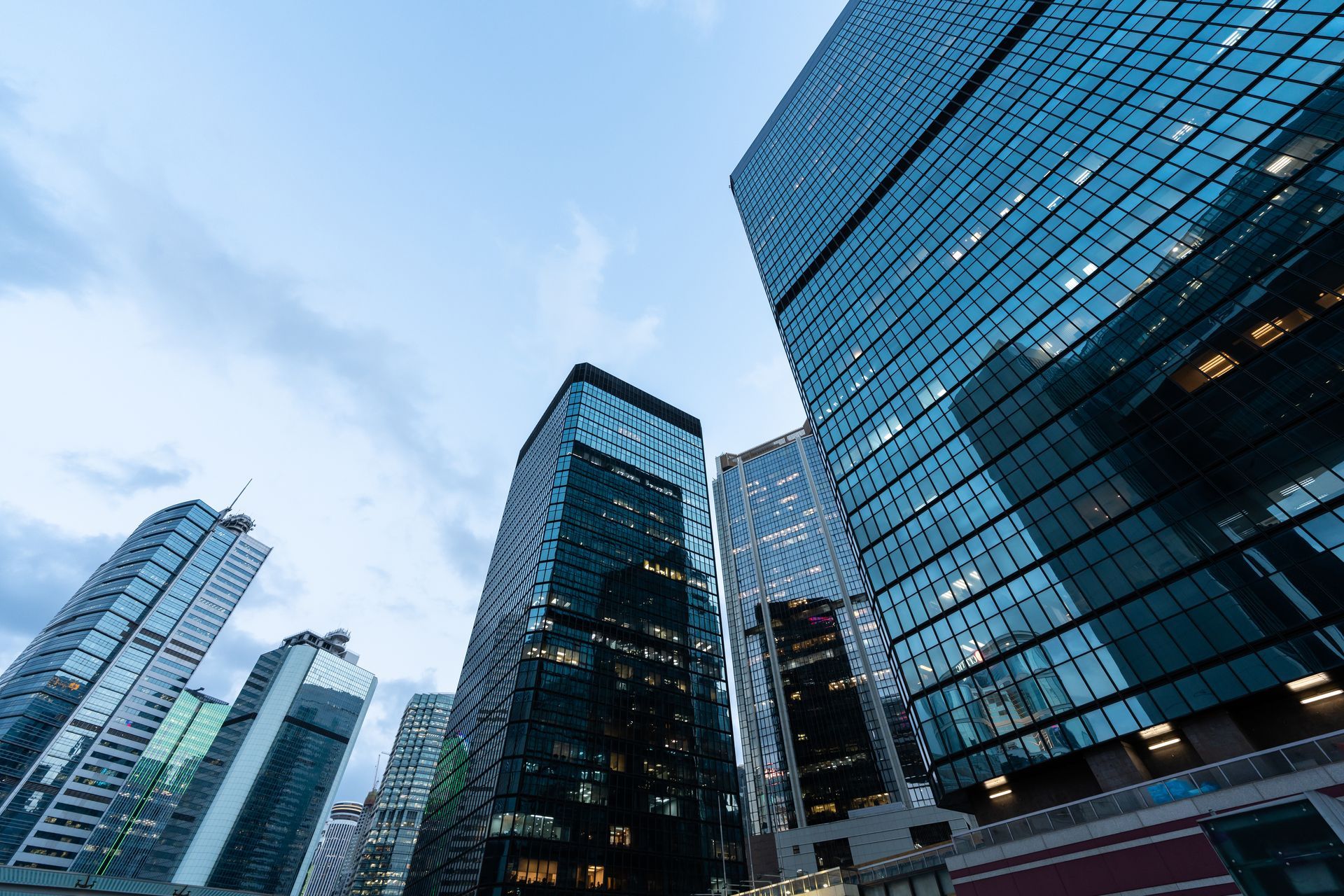 Modern glass skyscrapers against a blue sky in a city downtown Modern glass skyscrapers against a blue sky in a city downtown