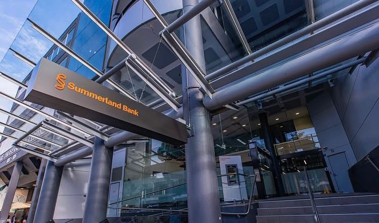 Sunshine Bank entrance with glass facade, steel canopy, and orange logo sign