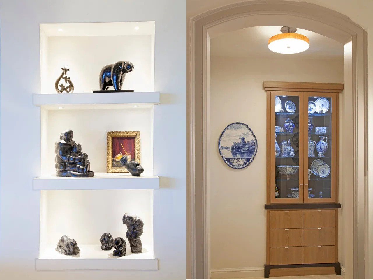 Hallway with lit built-in shelves displaying small sculptures beside an arched doorway and cabinet