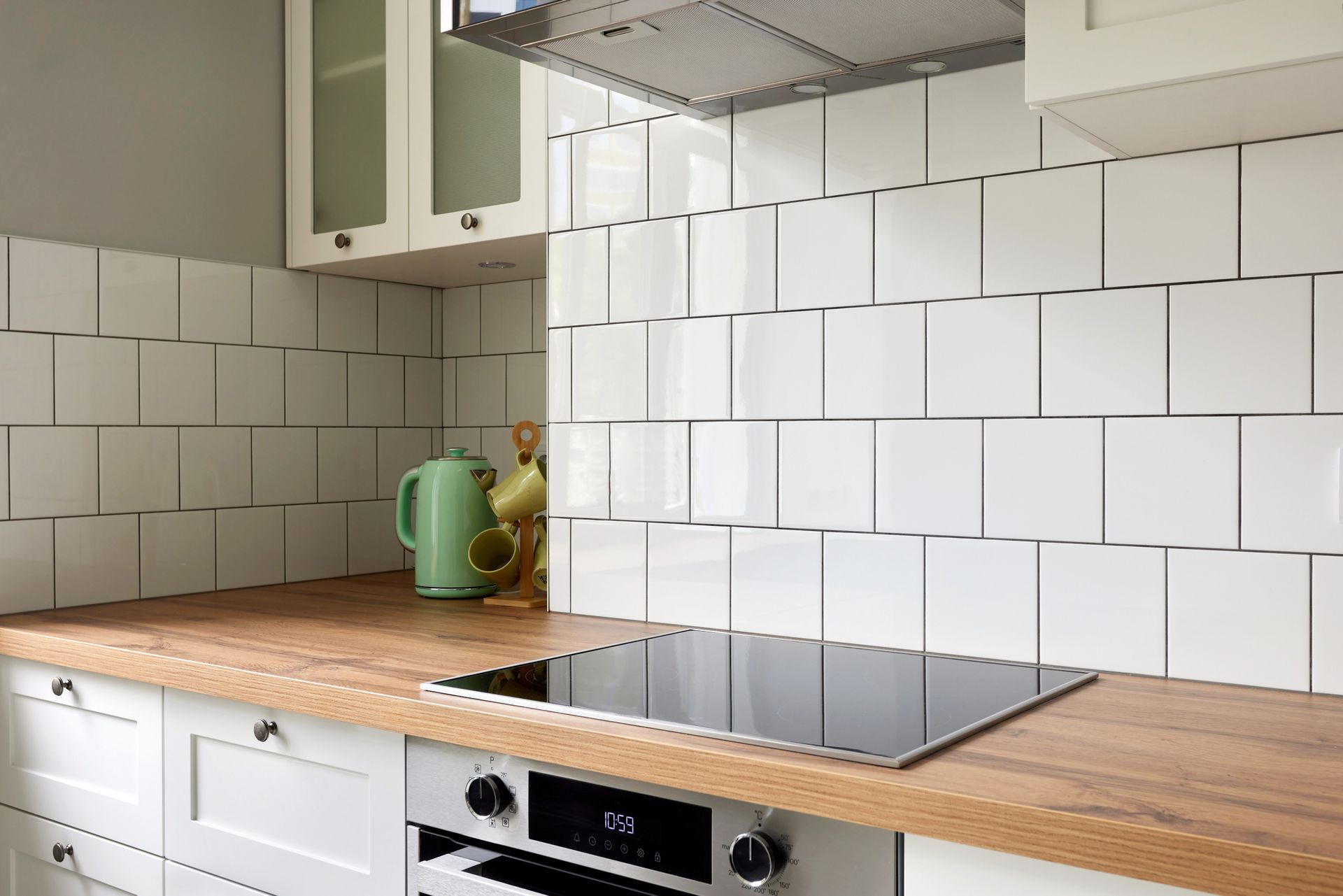 A kitchen under construction with white cabinets and a large island.