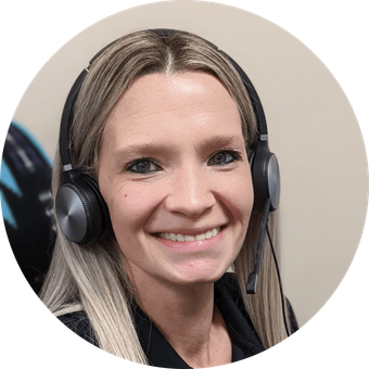 Woman with blonde hair and headset smiling.