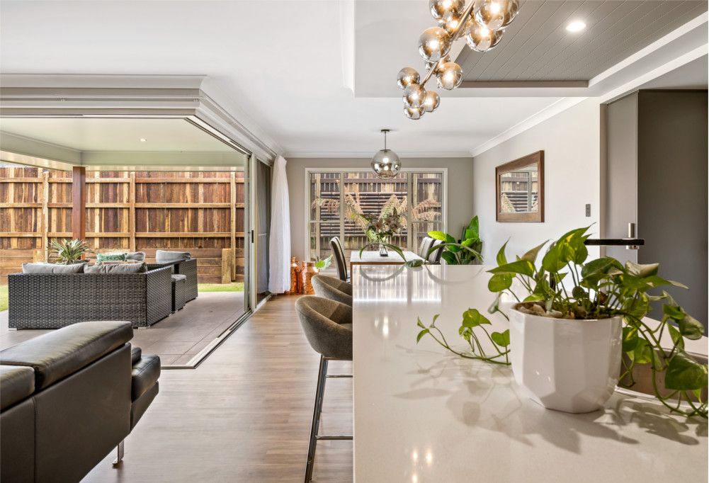 A staircase with two lights hanging from the ceiling — Peter Betros Homes in Highfields, QLD