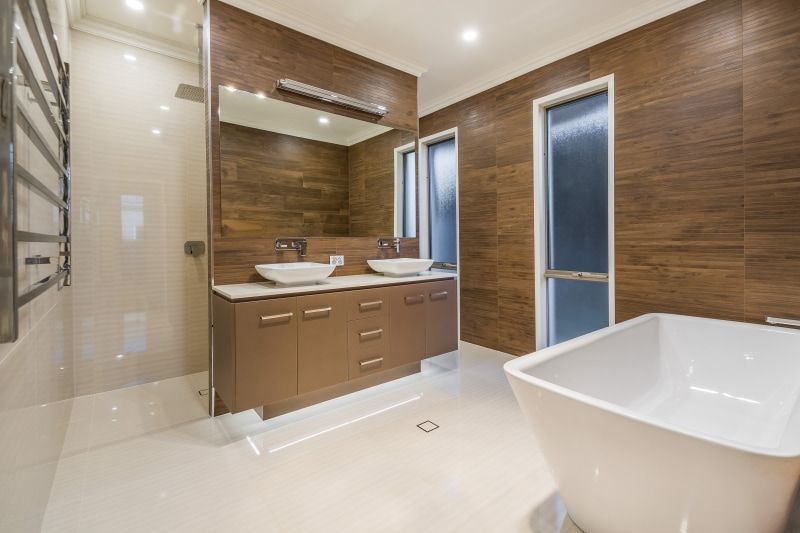 A Bathroom with Two Sinks and A Bathtub — Peter Betros Homes in Highfields, QLD