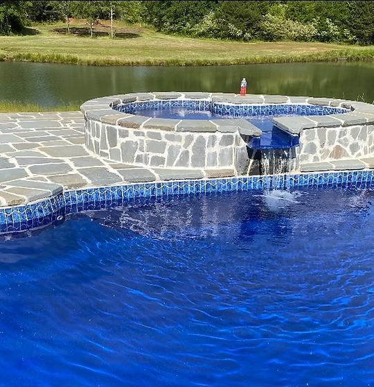 There is a waterfall in the middle of the pool.