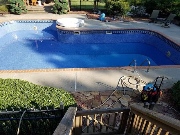A large swimming pool is being built in a backyard