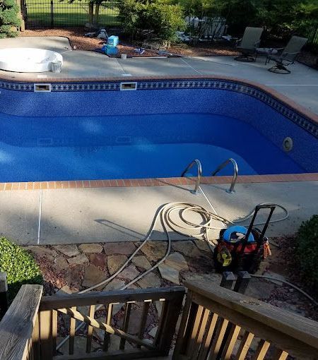 A large swimming pool with stairs leading to it