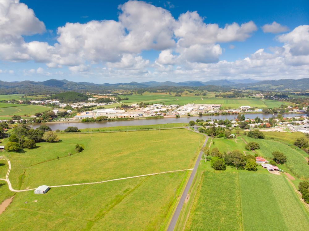 An Aerial View of a Lush Green Field With a River in the Background — Dean Gray Tiling In Murwillumbah, NSW