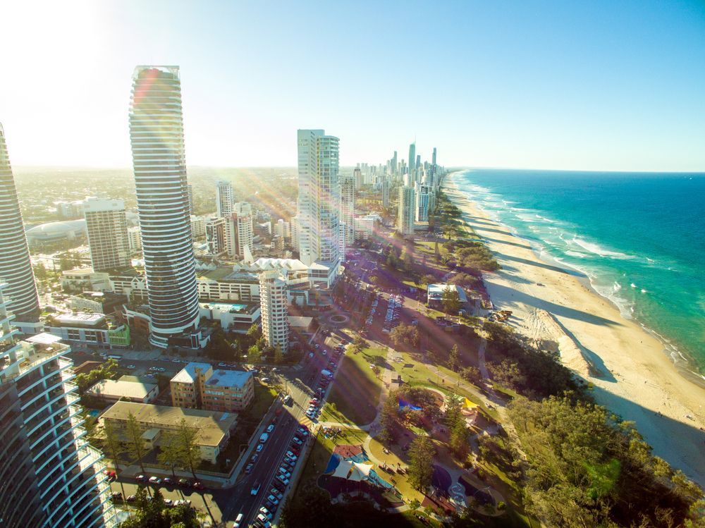 An Aerial View of a City With Tall Buildings and a Beach — Dean Gray Tiling In Robina, QLD