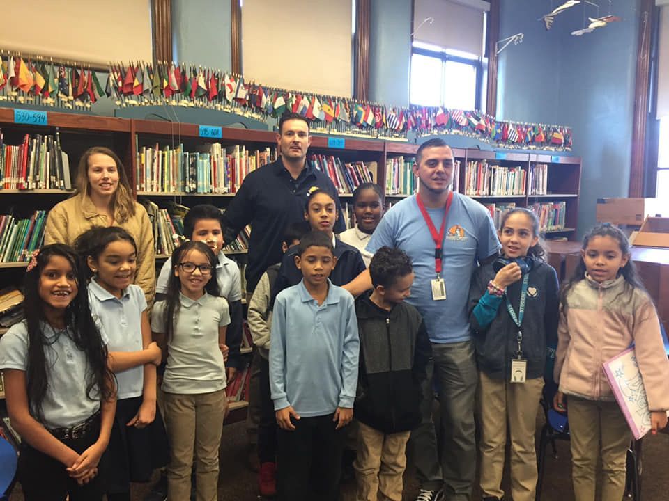 A group of people posing for a picture in a library