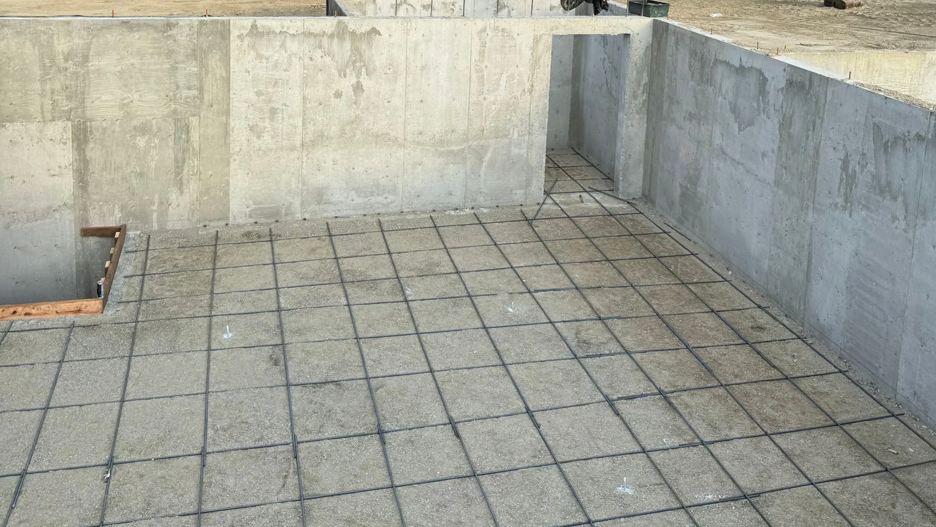 Slab-on-grade foundation installation for a commercial building prepared on compacted soil in North