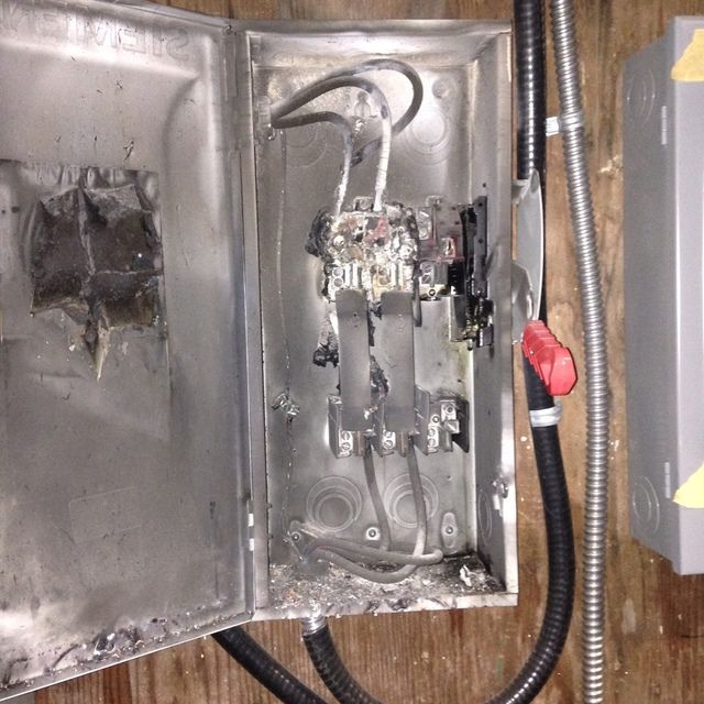 A metal box with electrical wires coming out of it