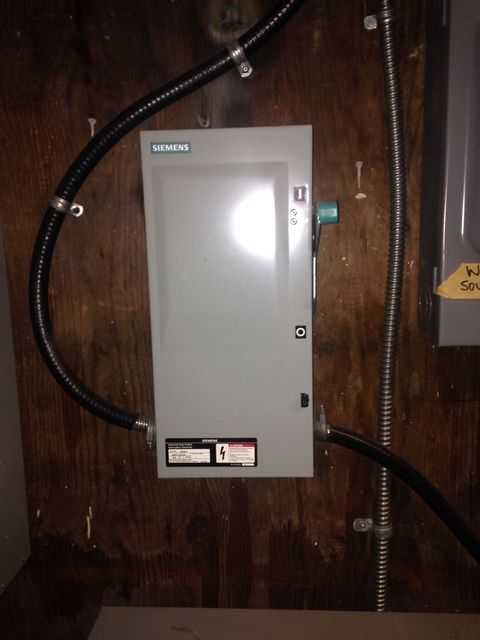 A siemens box is attached to a wooden wall