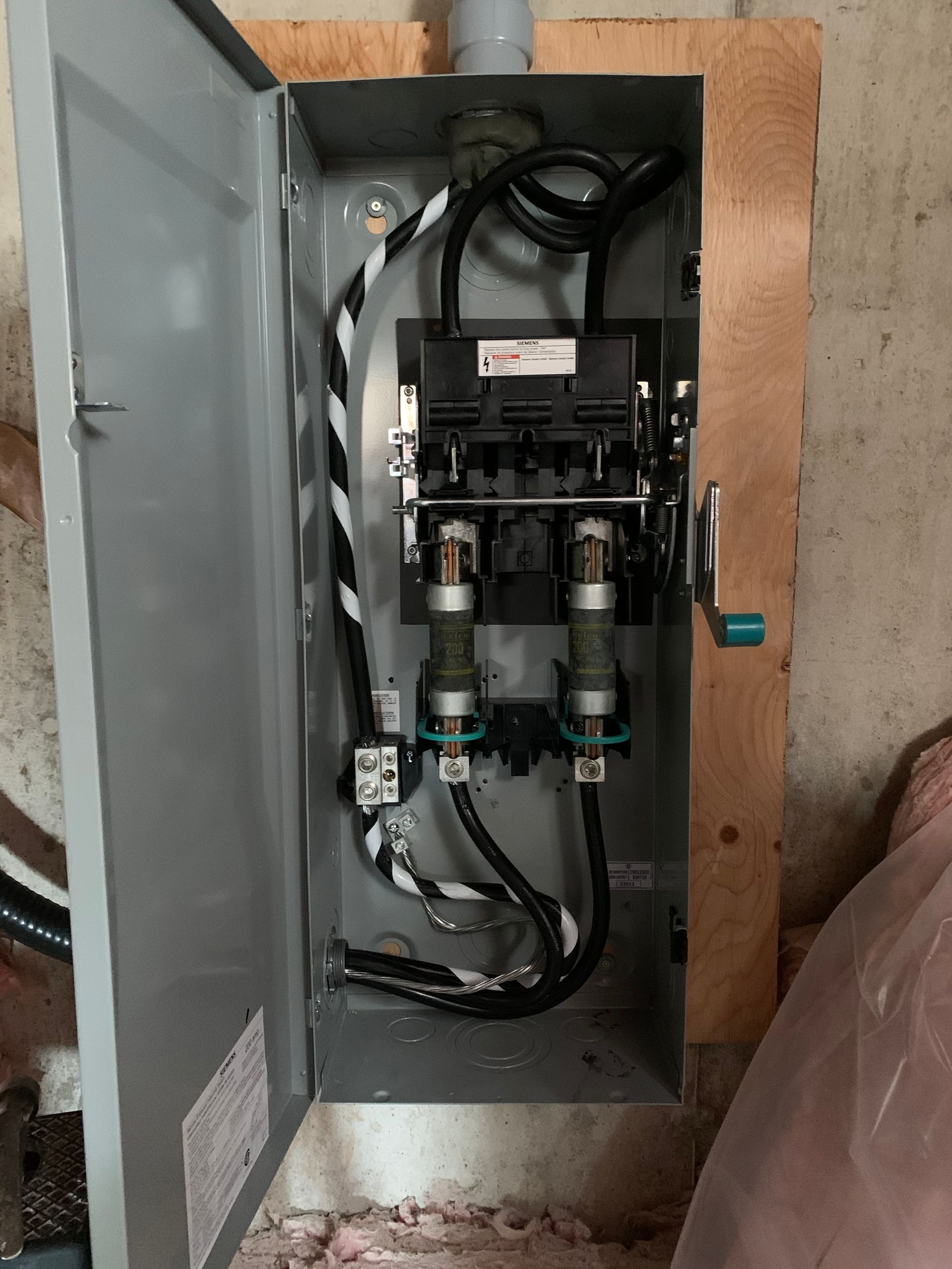 A electrical box with a lot of wires coming out of it.