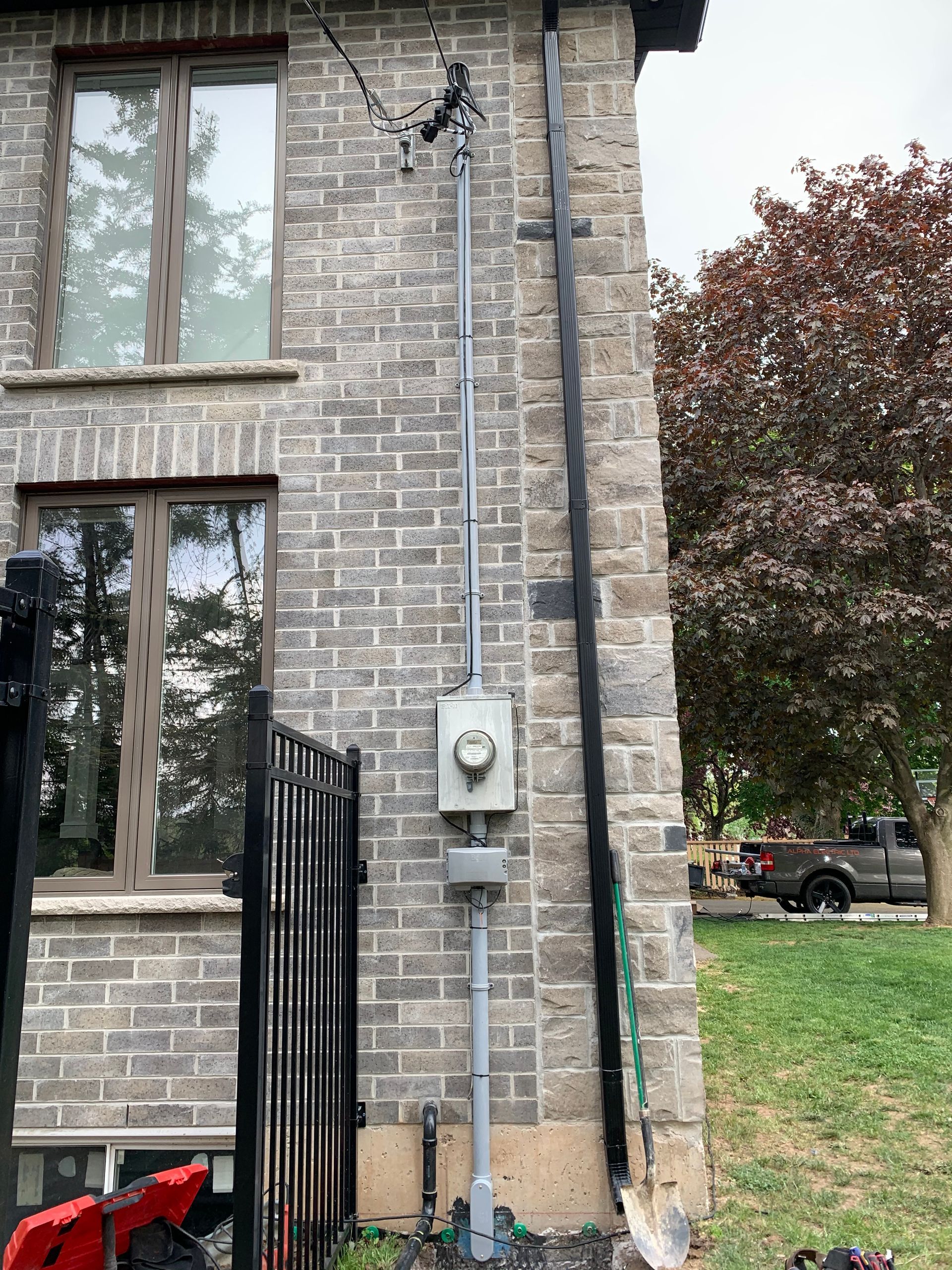 A brick building with a metal pipe attached to the side of it.