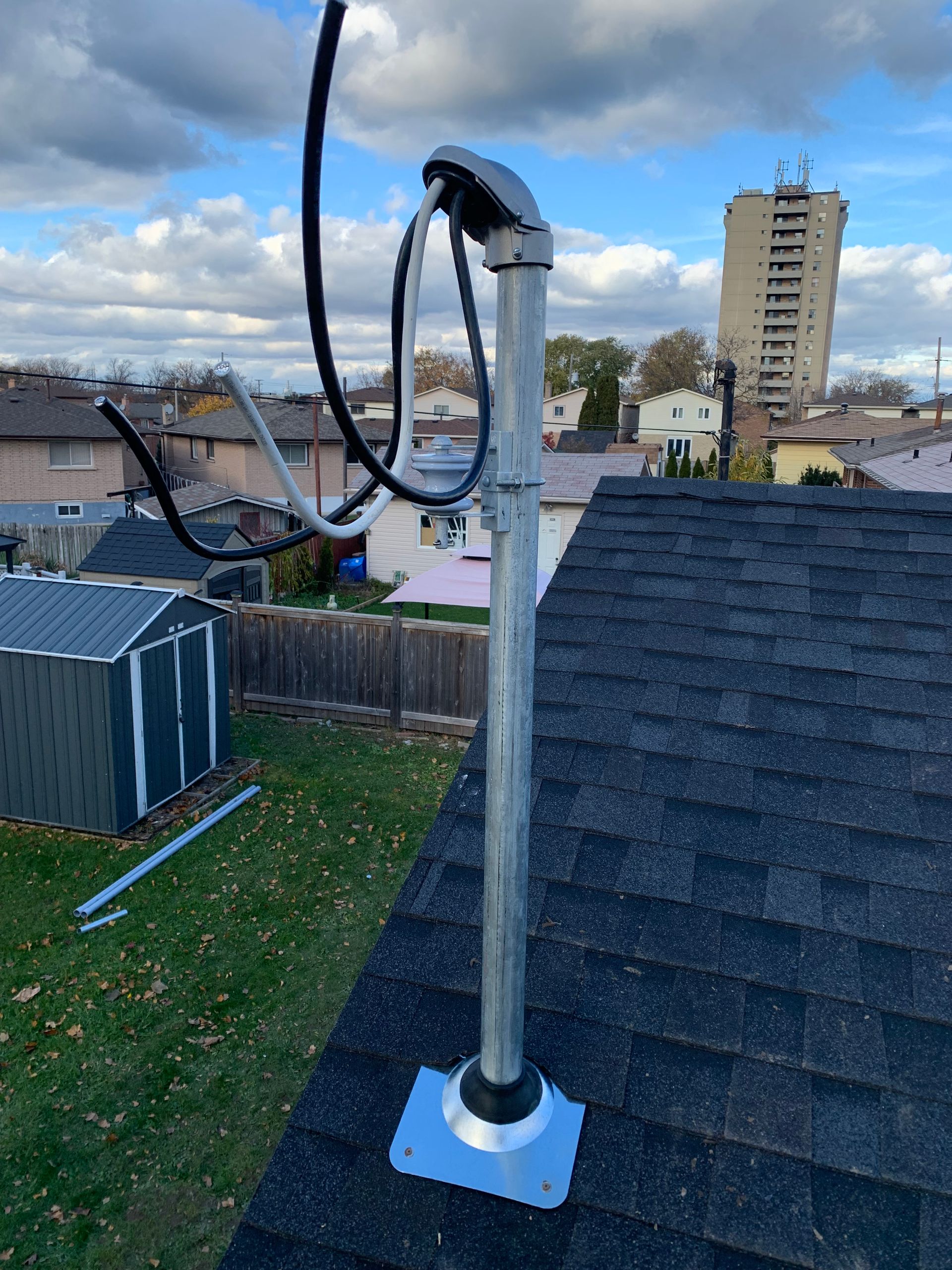 A metal pipe is sitting on top of a roof.