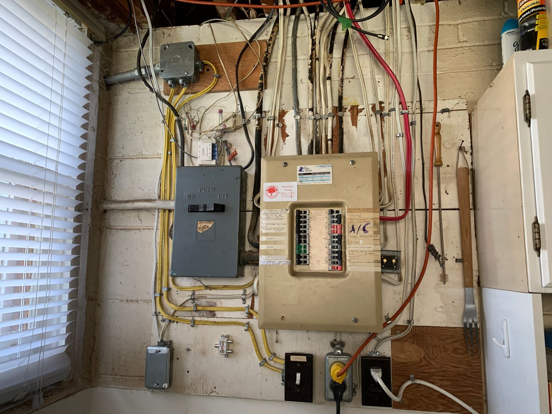 A wall with a lot of wires hanging from it.