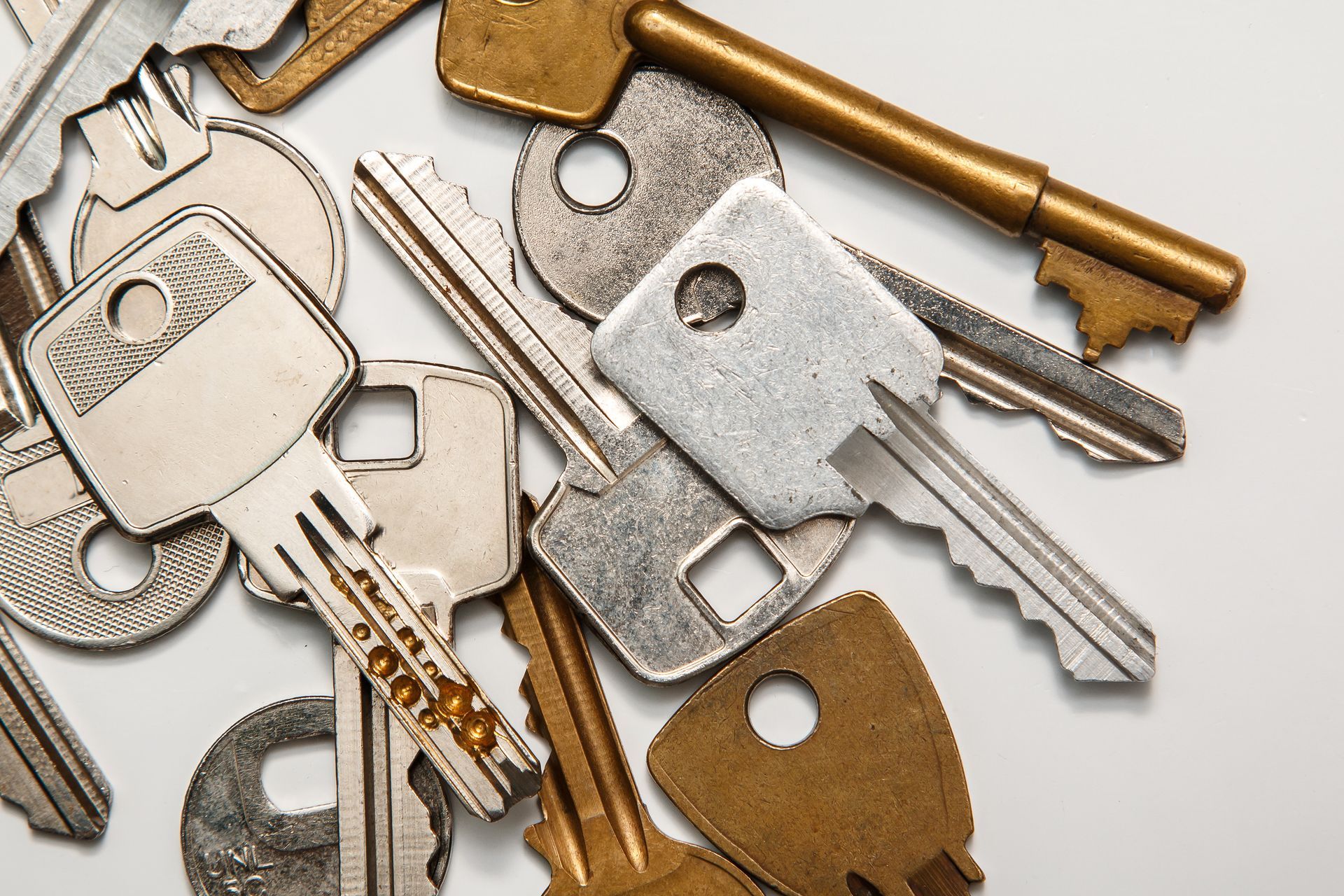Antique and modern keys scattered, each distinct in shape, size, and design. Antique and modern keys scattered, each distinct in shape, size, and design.