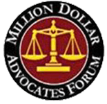 The logo for the million dollar advocates forum is a scale of justice in a circle.