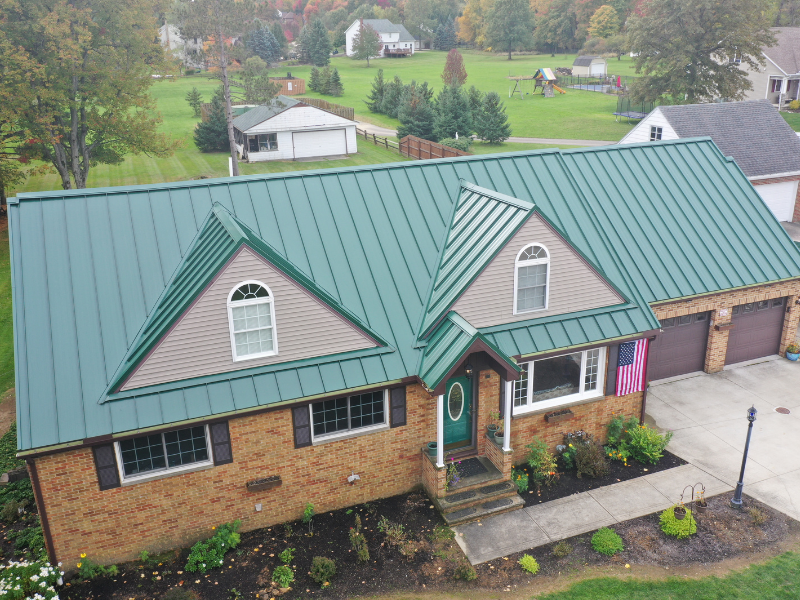 Green Metal Roof With Tan Siding