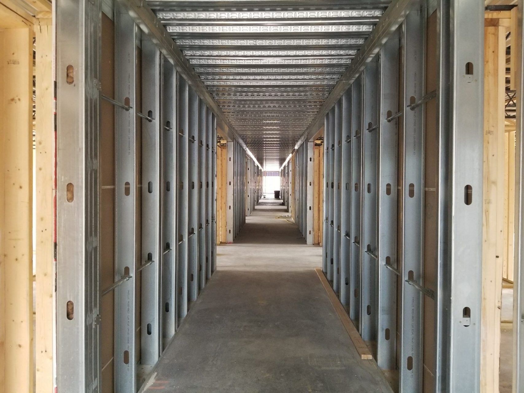 A long hallway in a building under construction.