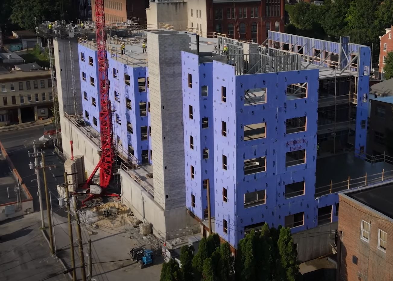 An aerial view of a building under construction in a city.