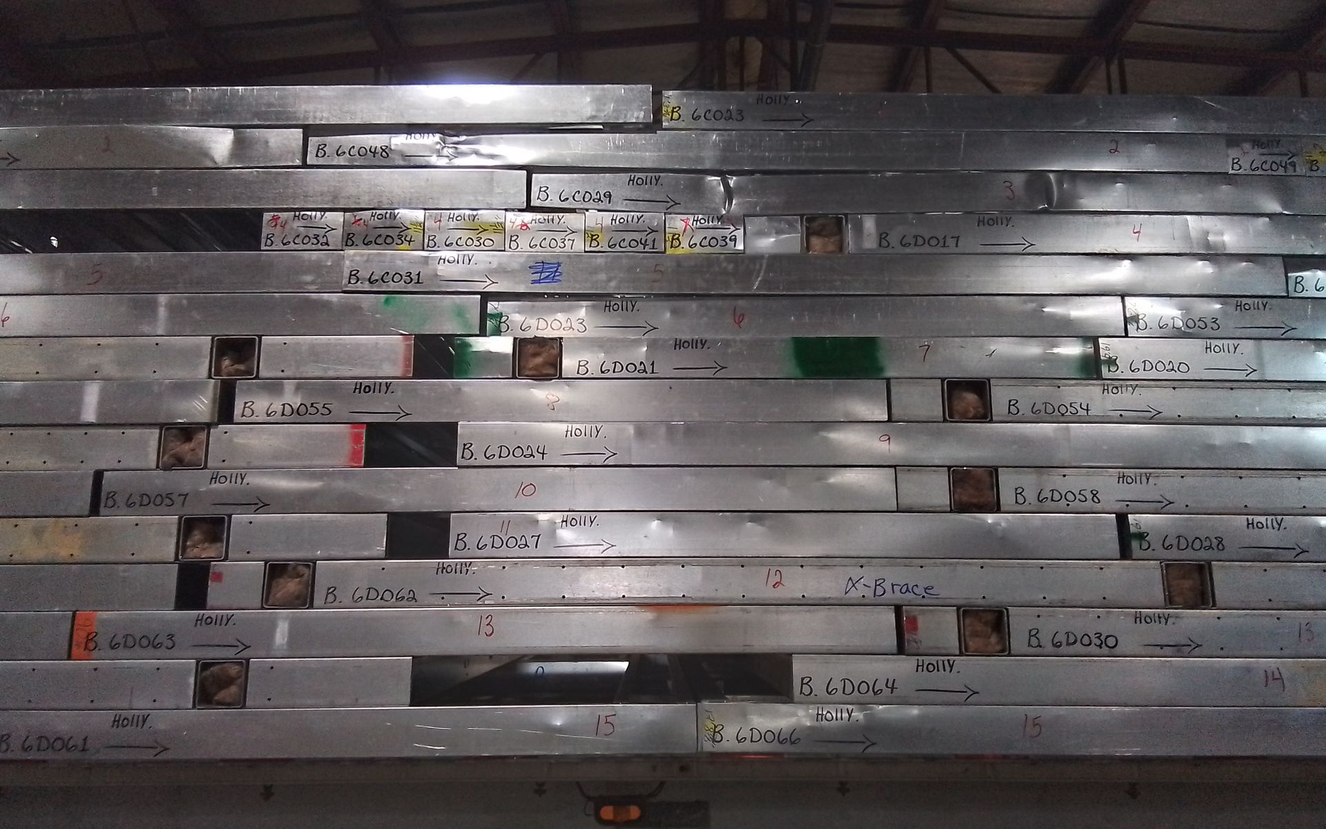 Steel prefab walls stacked in dim lighting.