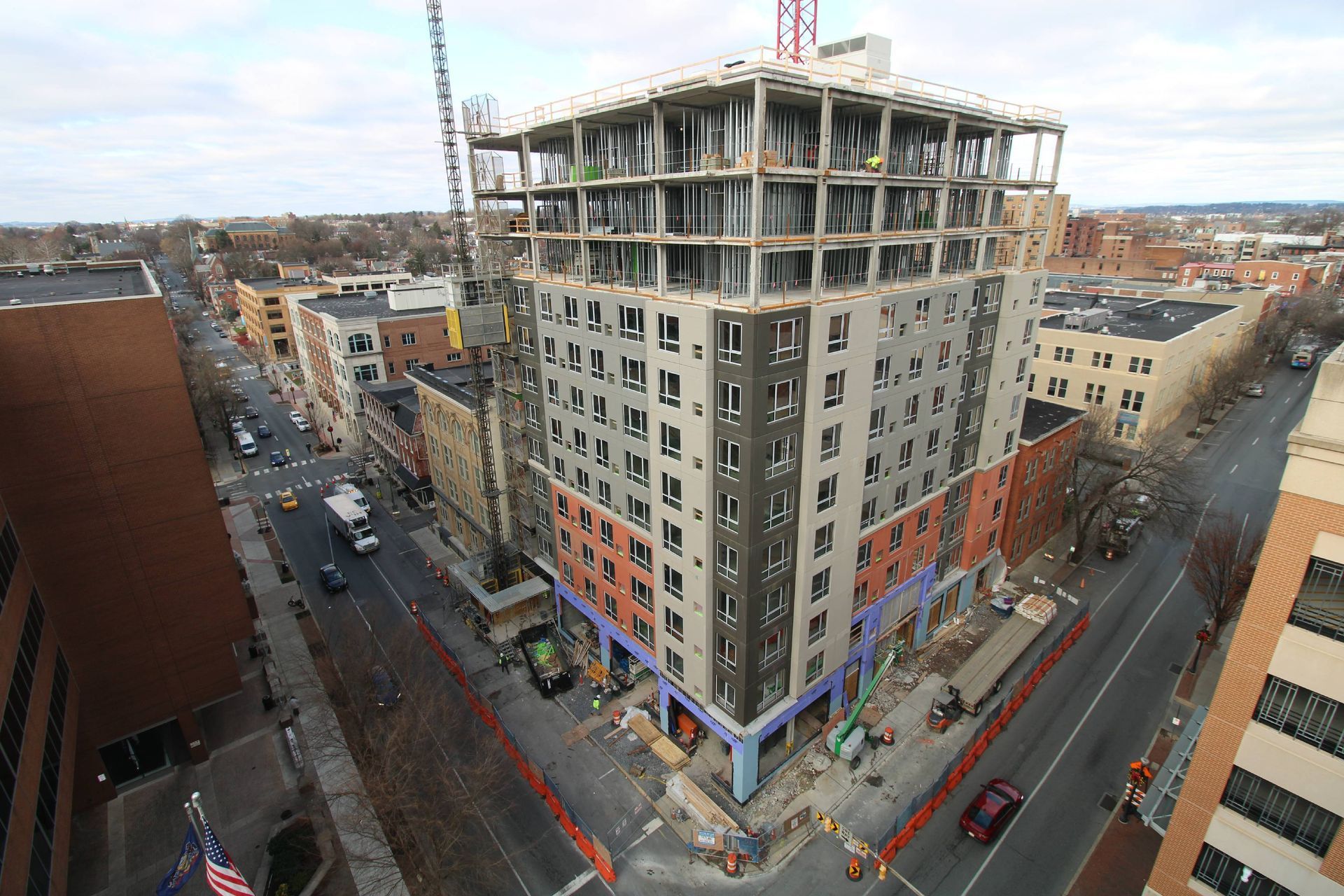 An aerial view of a building under construction in a city.