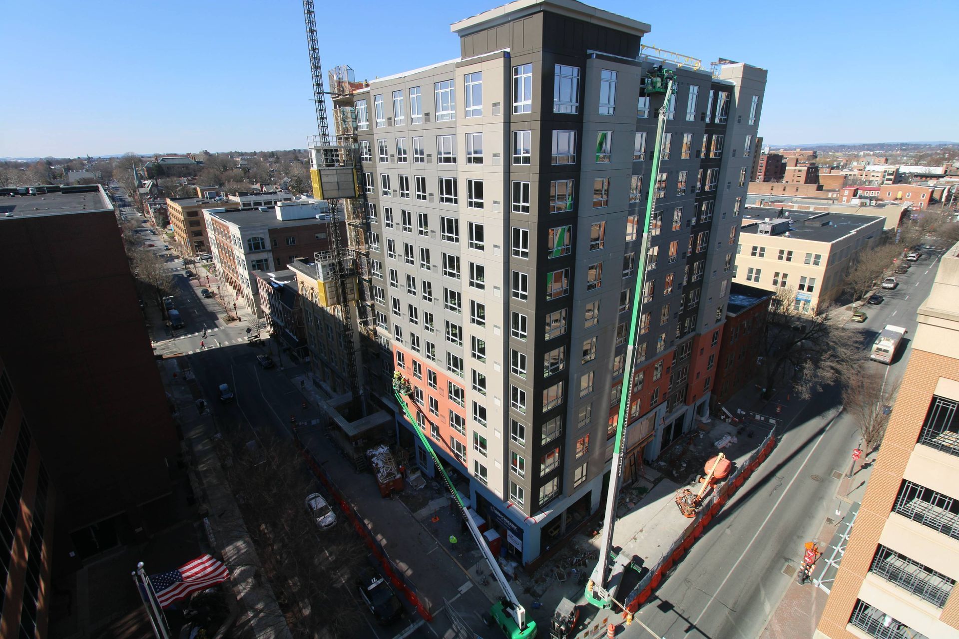 An aerial view of a building under construction in a city.
