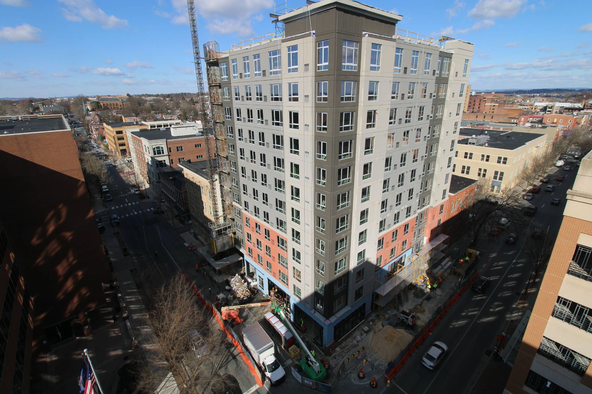 An aerial view of a building under construction in a city.