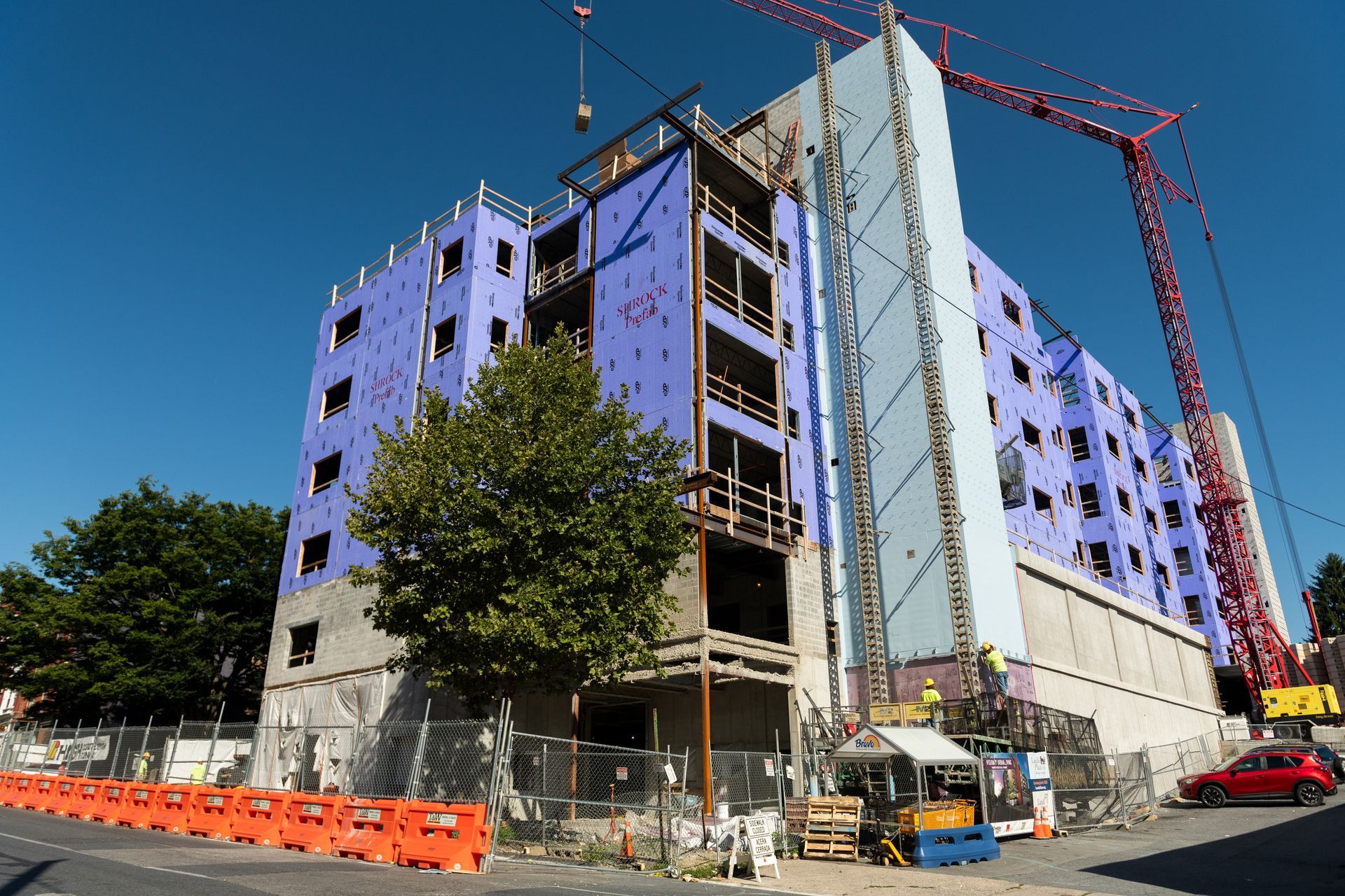 A large building is being built with a crane in the background.