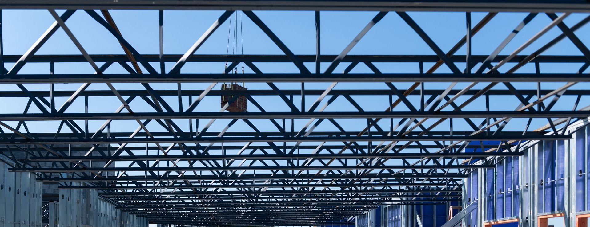 A large metal structure with a blue sky in the background