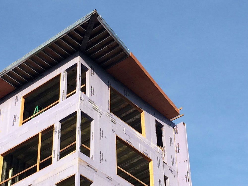 A building under construction with a blue sky in the background