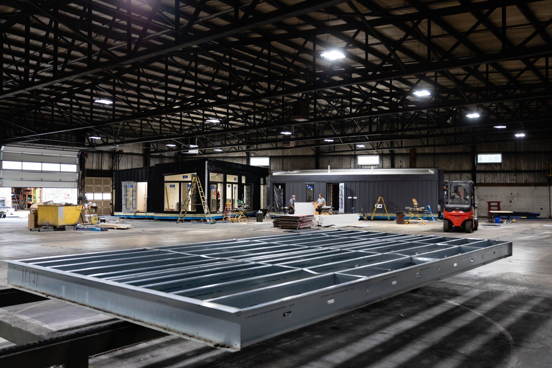 Large industrial warehouse with a metal platform in the foreground and equipment in the background.