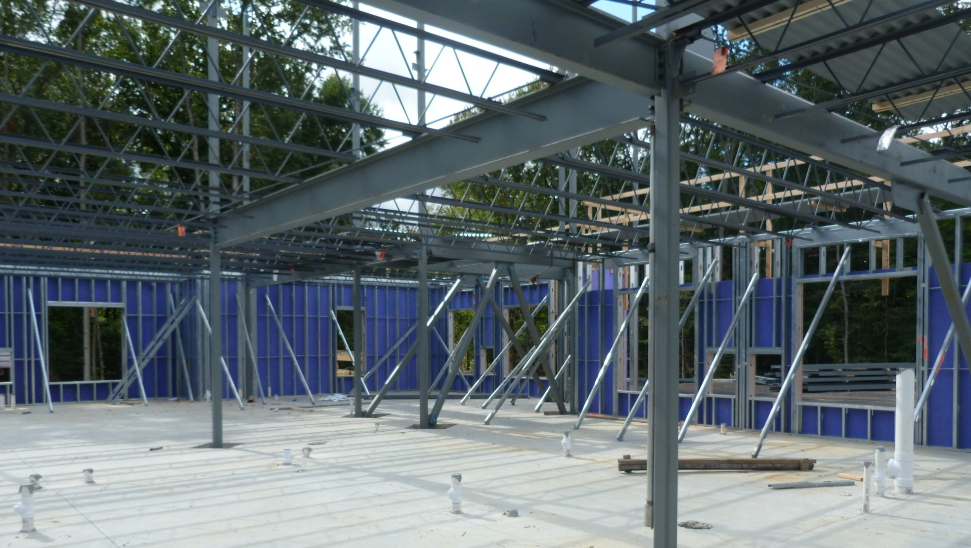 The inside of a building under construction with blue walls.