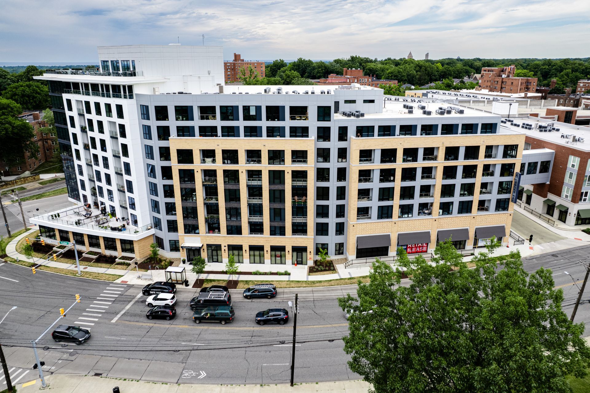 An aerial view of a large building with cars parked in front of it.