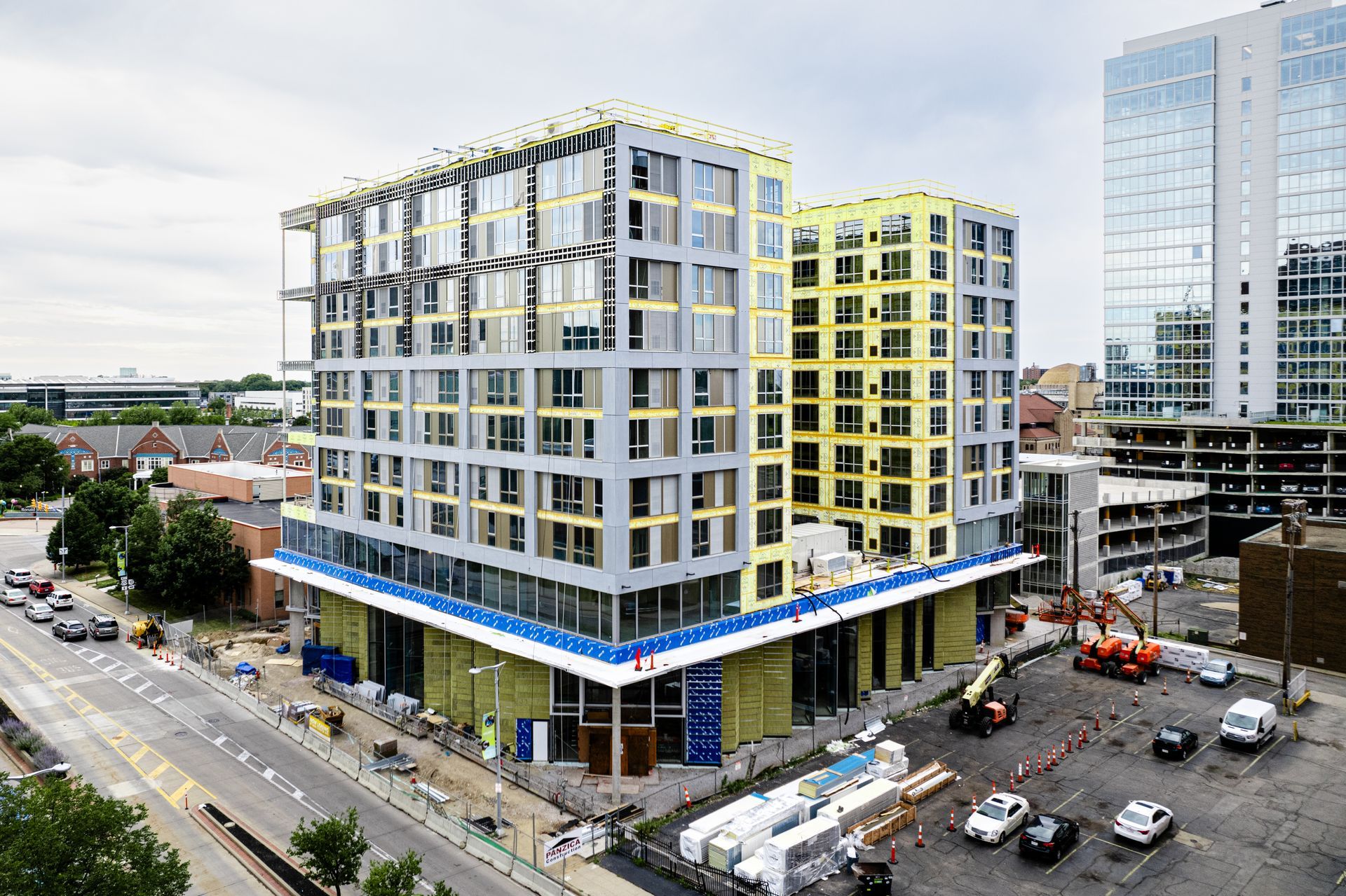 An aerial view of a building under construction in a city.