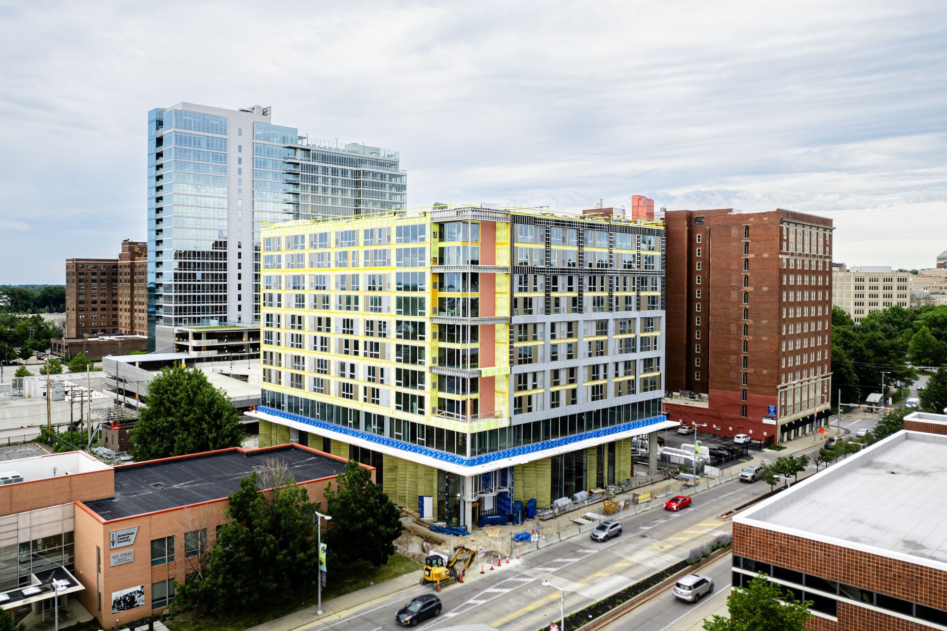 An aerial view of a building under construction in a city.