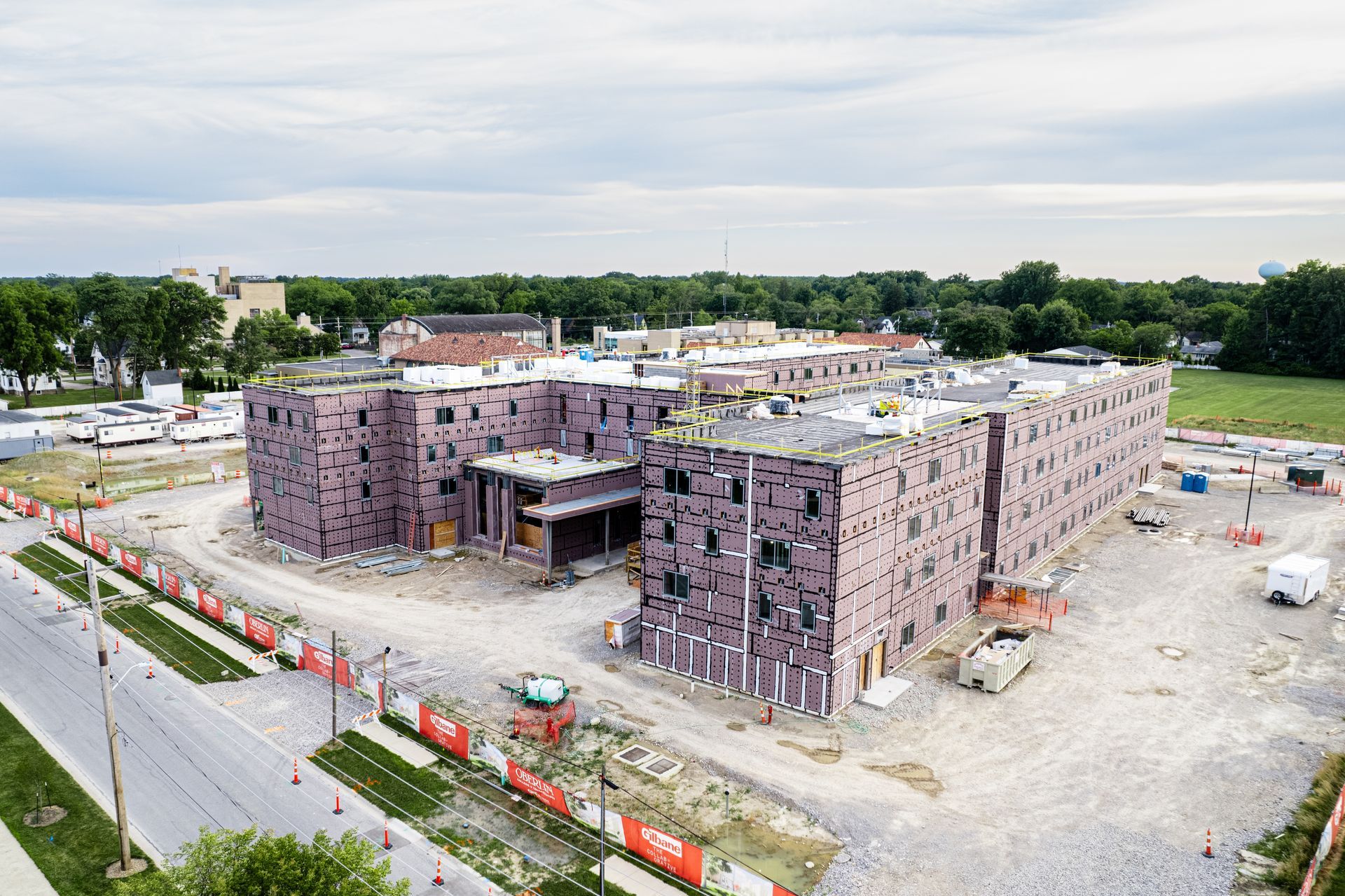 An aerial view of a large building under construction in a city.