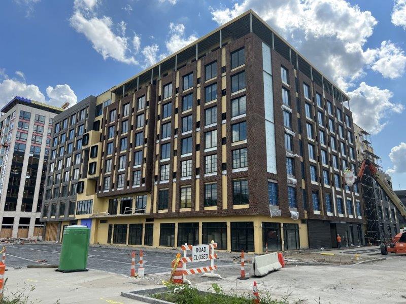 A large building with a lot of windows is under construction.