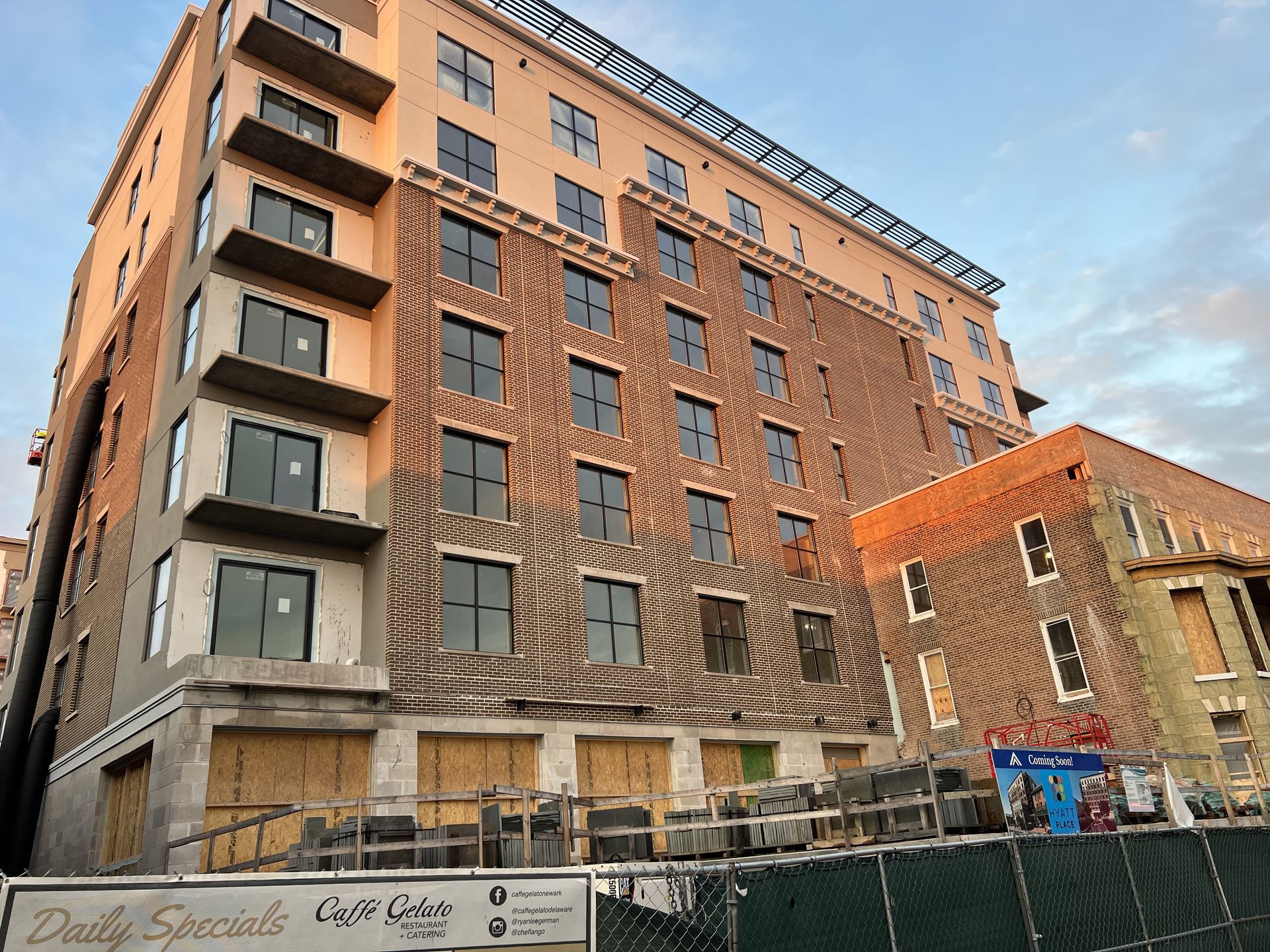 A large building with a lot of windows is under construction.