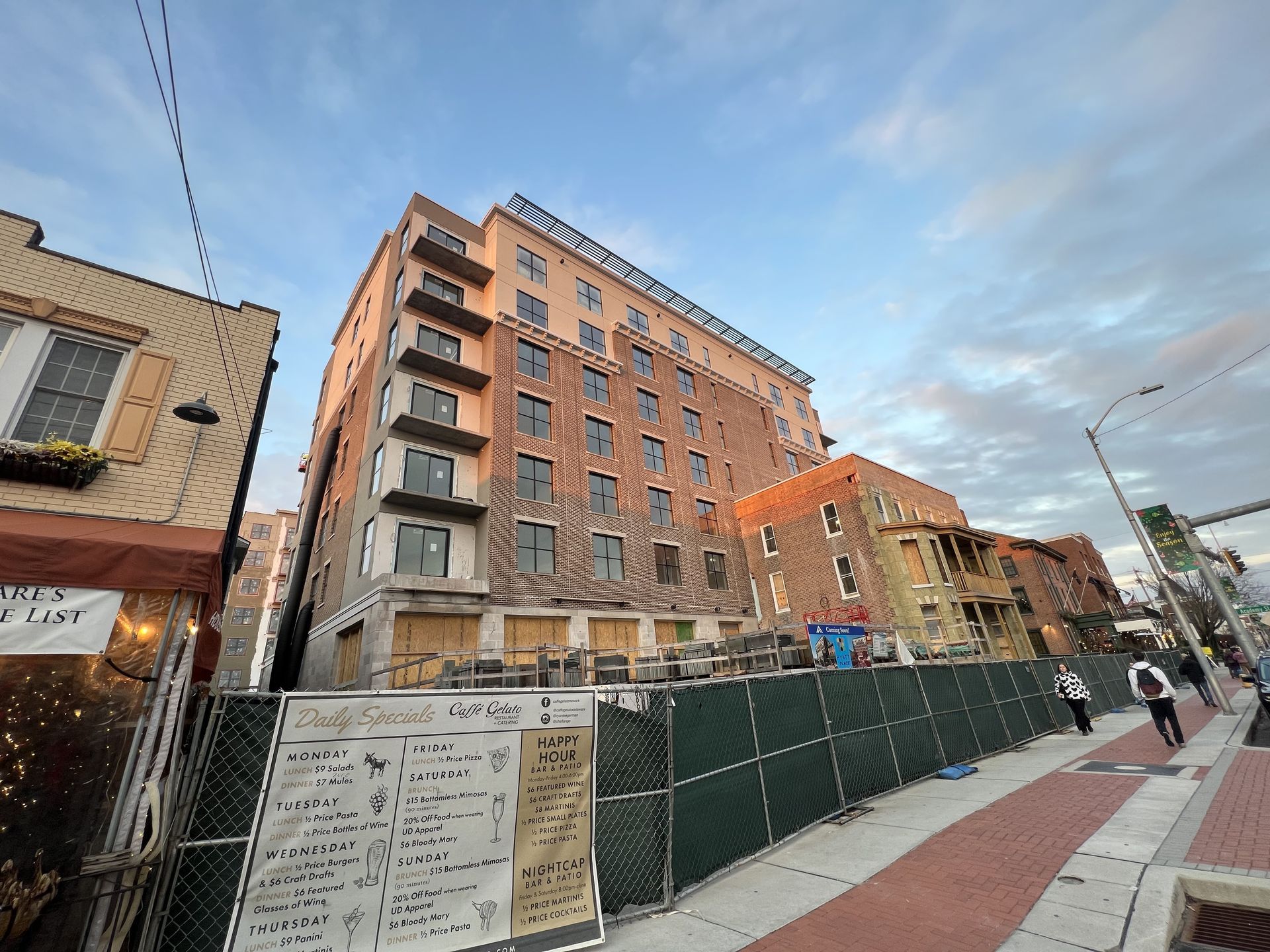 A large building with a fence around it is under construction.