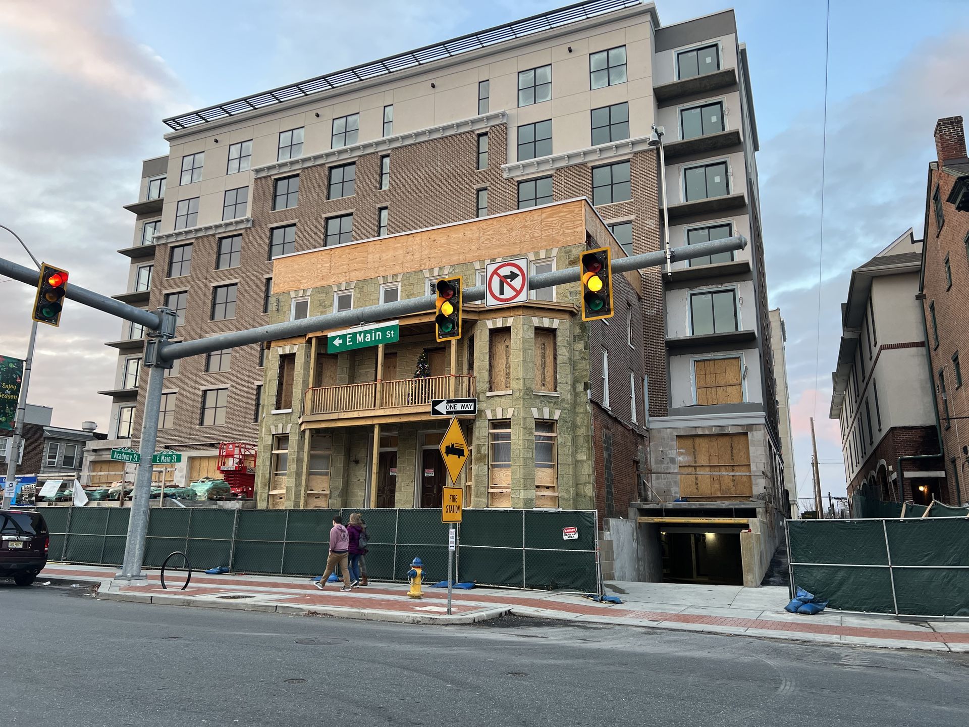 A building under construction with a no parking sign in front of it.