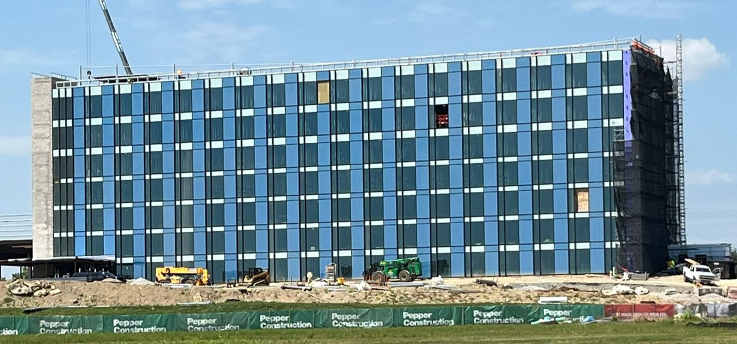 Large multi floor hotel with windows with blue sky