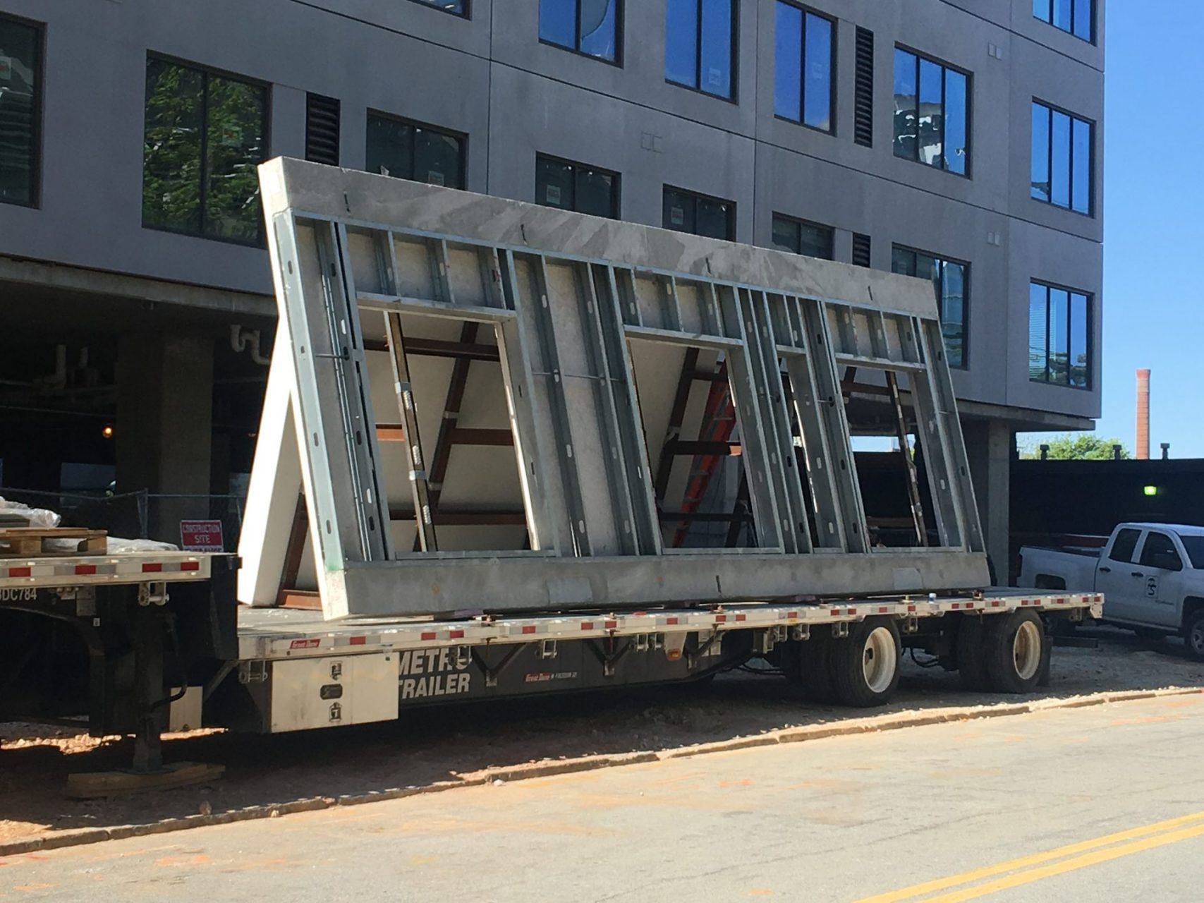 A large piece of steel is on a flatbed truck.