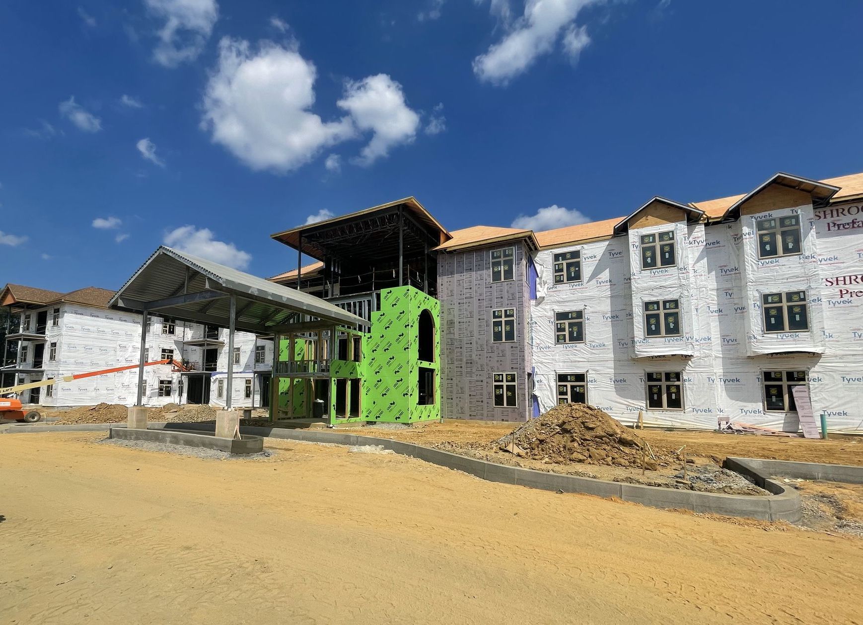 A large building under construction with a blue sky in the background.
