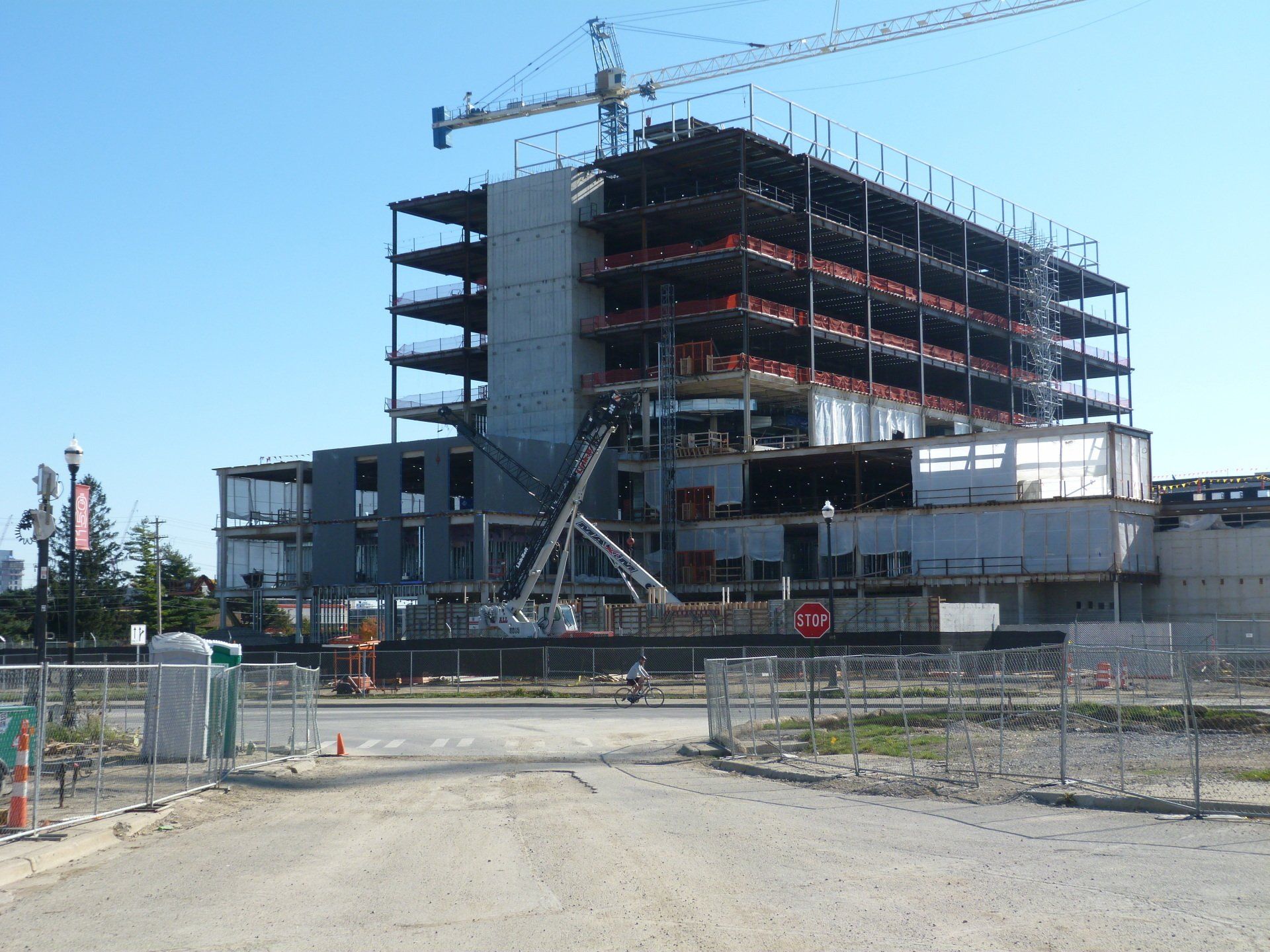 A large building under construction with a crane in the background.