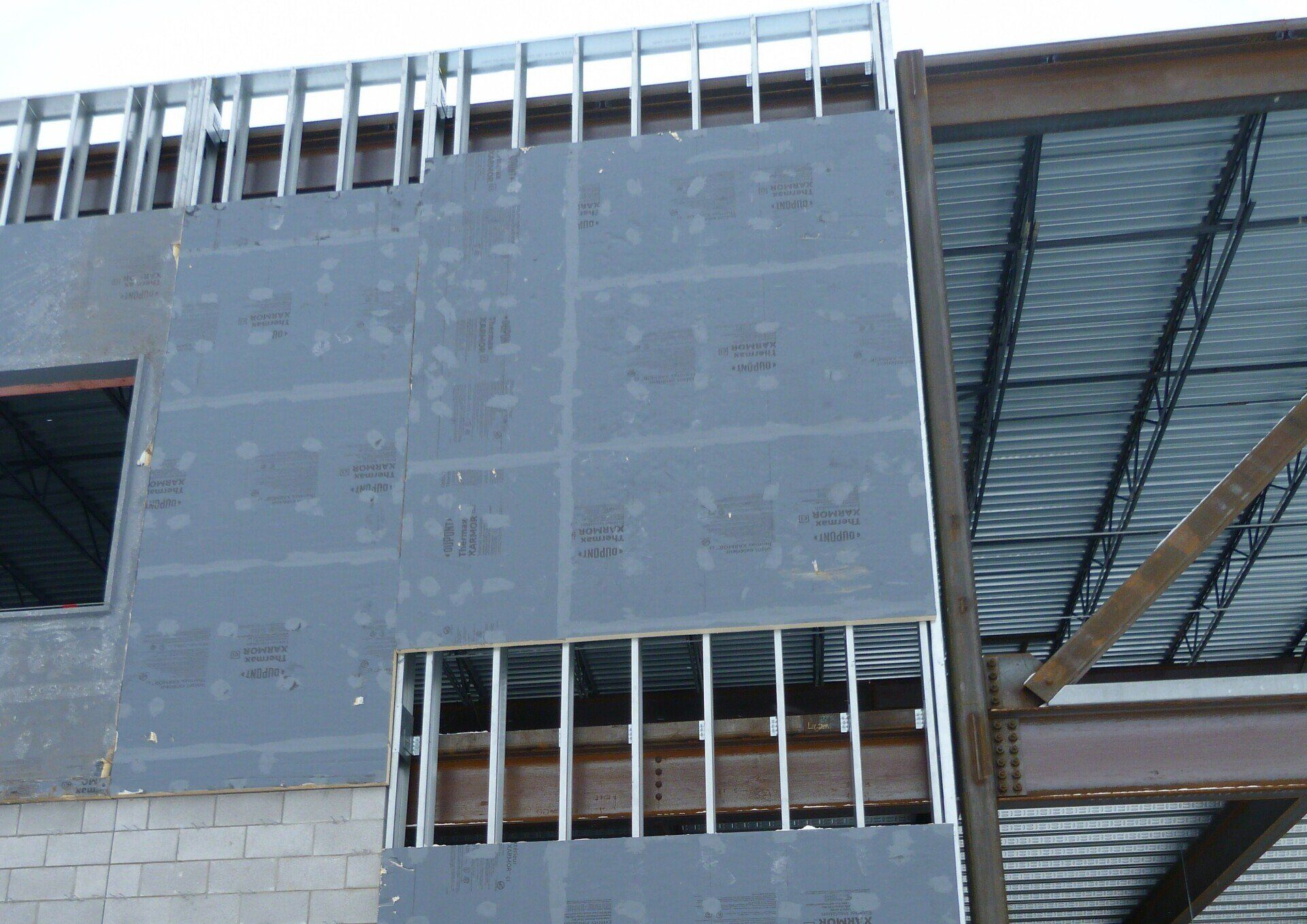 A large building under construction with a metal roof.