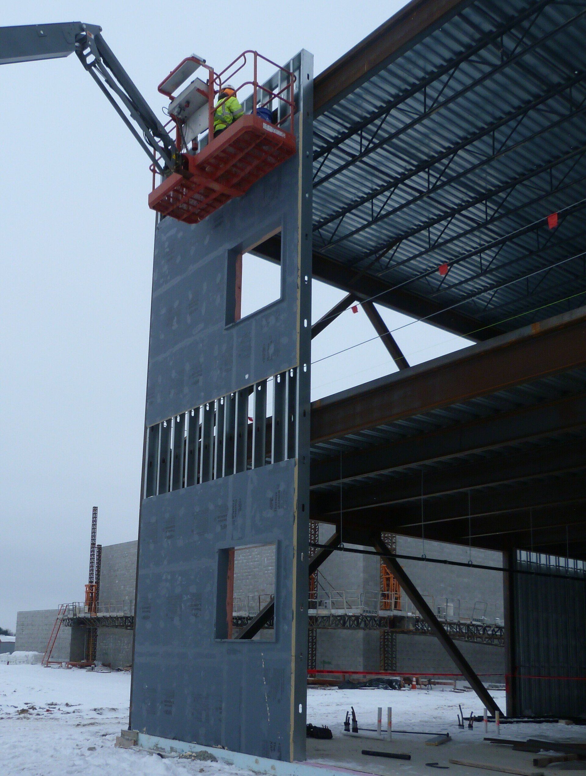 A building under construction with a crane on top of it.