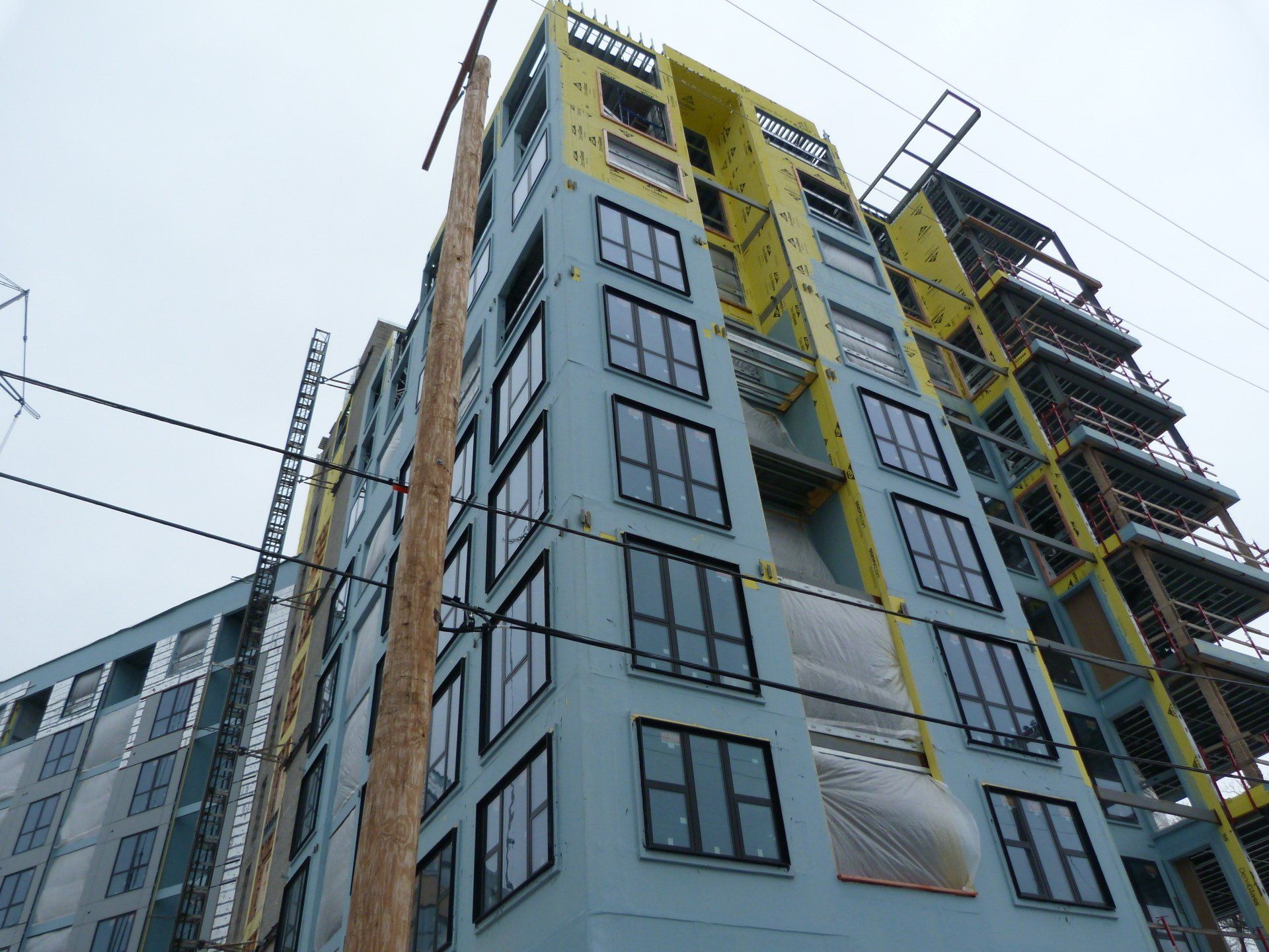 A tall building under construction with a lot of windows.